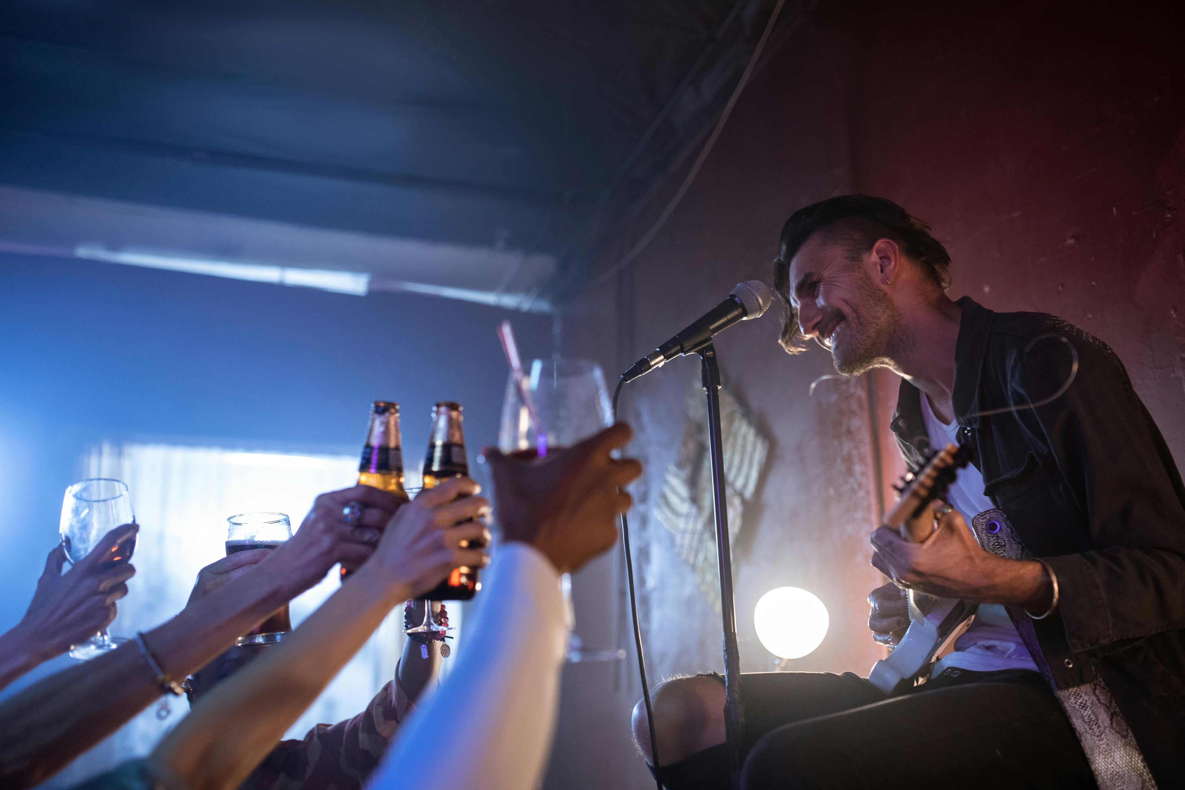 Live performer engaging with crowd at a venue